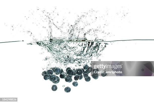 blueberries diving in clear water - falling blueberries stock pictures, royalty-free photos & images