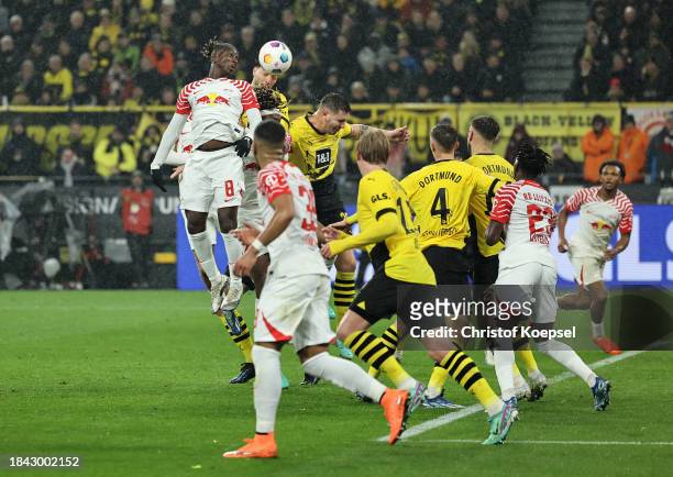 Amadou Haidara of RB Leipzig heads the ball before Rami Bensebaini of Borussia Dortmund scores an own goal, the first goal for RB Leipzig during the...