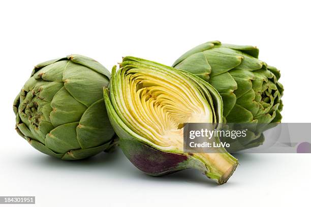 close-up of fresh artichokes on white background - artichoke stock pictures, royalty-free photos & images