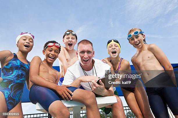 coach cheering with young swimmers - swim coach stock pictures, royalty-free photos & images