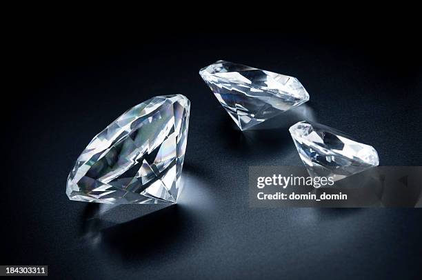 three beautiful diamonds on a black background. - diamonds stock pictures, royalty-free photos & images