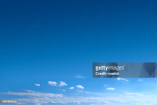 clear blue sky background with scattered clouds - sky stock pictures, royalty-free photos & images