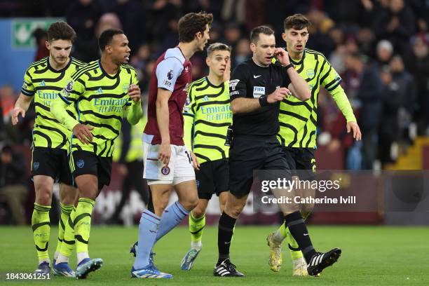 Referee, Jarred Gillett is spoken to by Pau Torres of Aston Villa and Kai Havertz of Arsenal during the Premier League match between Aston Villa and...