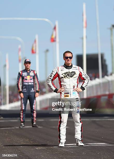 Greg Murphy and Craig Lowndes look on as the Peter Brock Trophy is deleivered to the circuit by police helicopter prior to the Bathurst 1000, which...