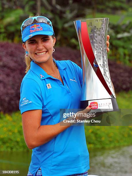 Lexi Thompson of USA poses with the Sime Darby LPGA Trophy after she won 19 under 265 during day four of the Sime Darby LPGA at Kuala Lumpur Golf &...