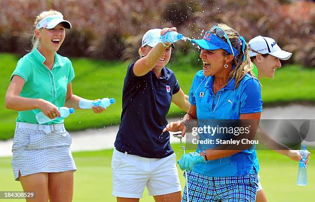 Stacy Lewis of USA pours water on Lexi Thompson of USA while Jessica Korda of USA looks on after Lexi Thompson won by 19 under 265 on the 18th hole...