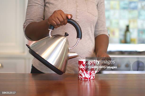 african woman making tea, cape town, south africa - womens indoor cup 2013 stock pictures, royalty-free photos & images