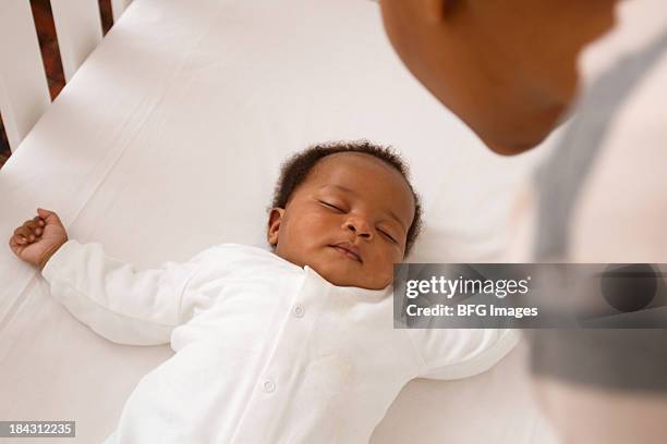 african baby sleeping in crib, cape town, south africa - african ethnicity baby stock pictures, royalty-free photos & images