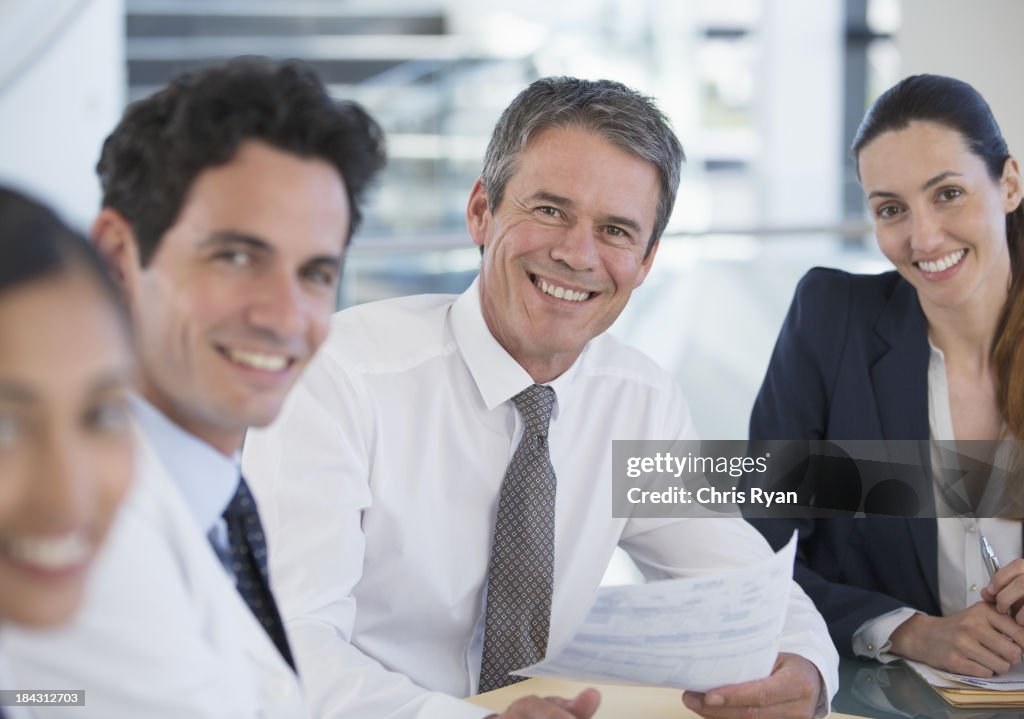 Portrait of smiling doctors and business people in meeting