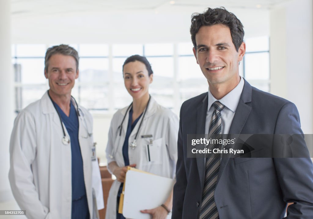 Portrait of confident businessman and doctors