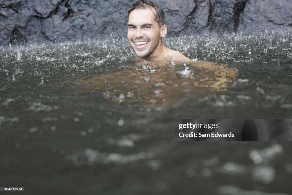 Rain falling on man in lake