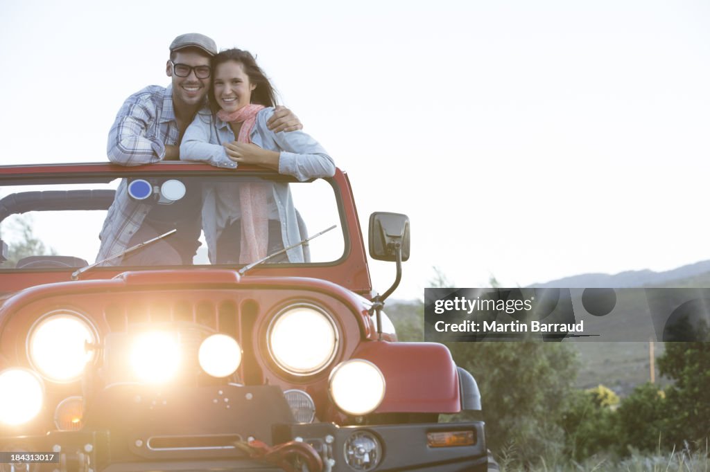 Couple hugging in sport utility vehicle