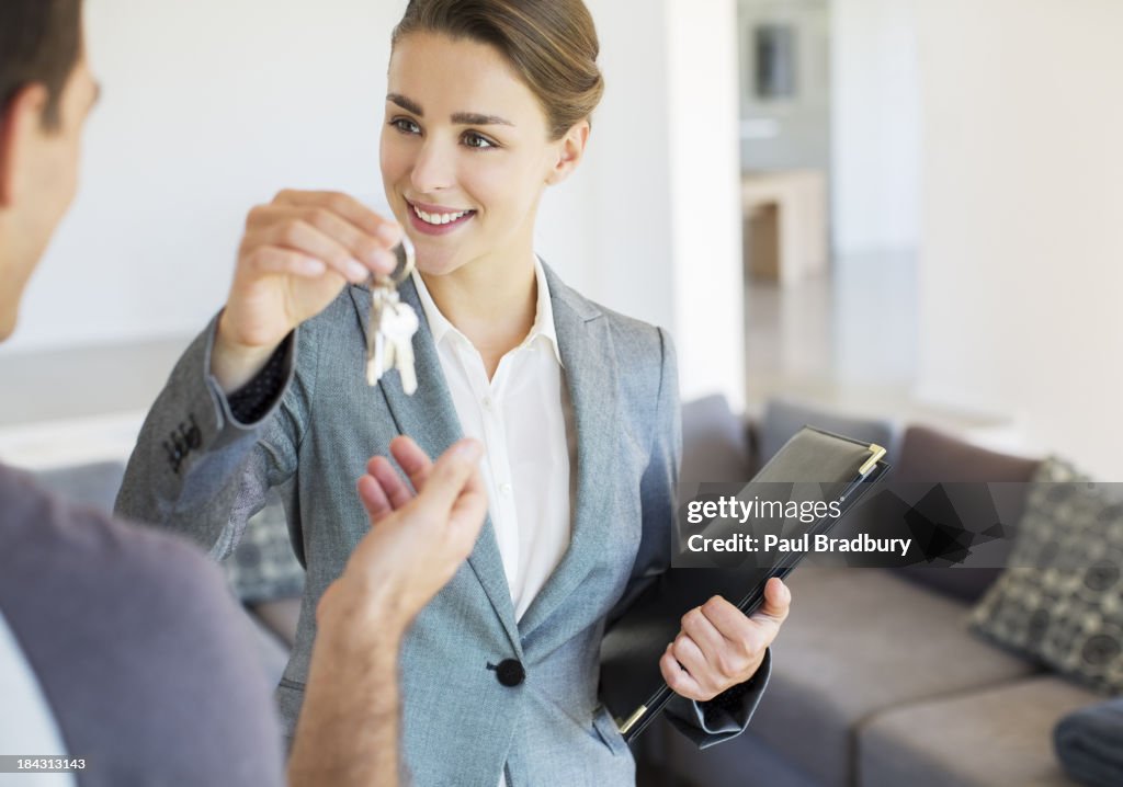 Real Estate Agent giving man keys to new house