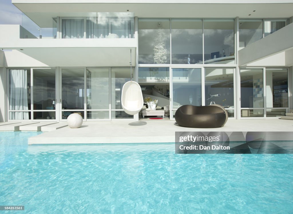 Sedie per piscina all'esterno della casa moderna