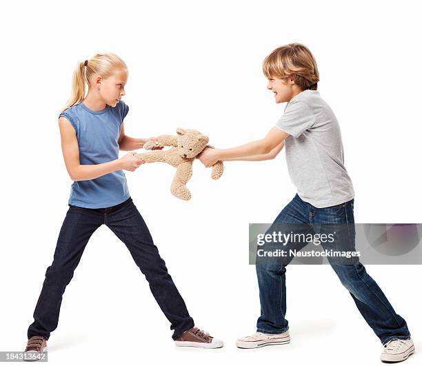 siblings fighting over a toy - isolated - brother fight stock pictures, royalty-free photos & images