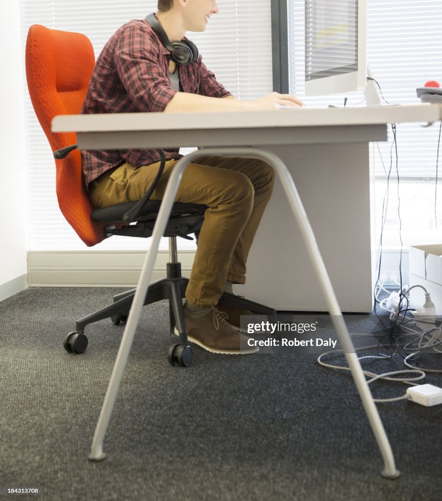 Businessman using computer at desk in office