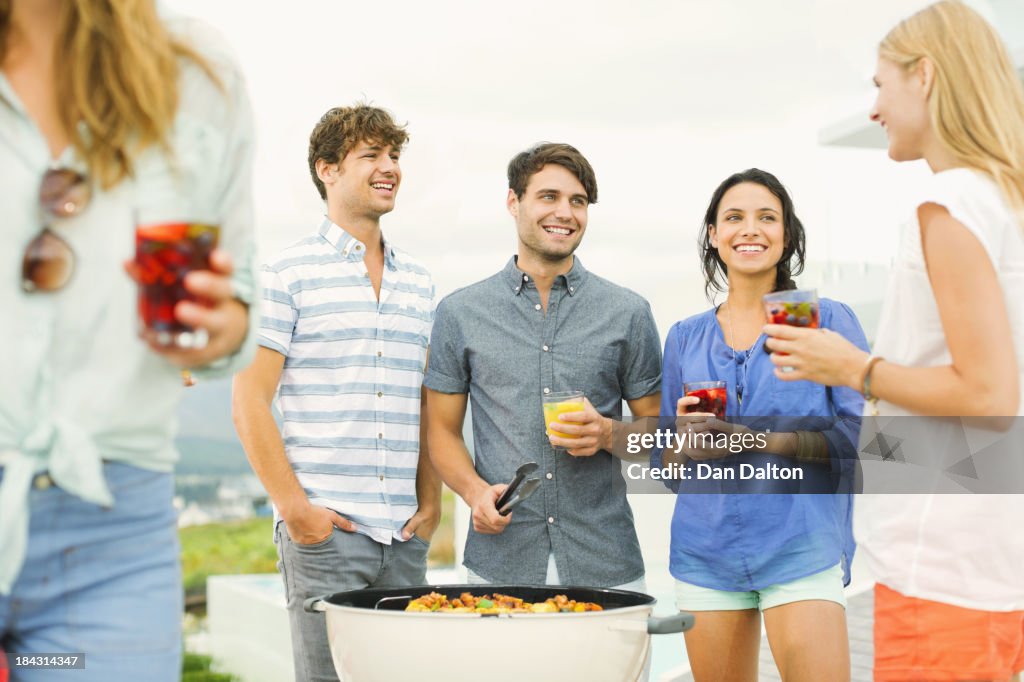 Friends enjoying drinks at barbecue