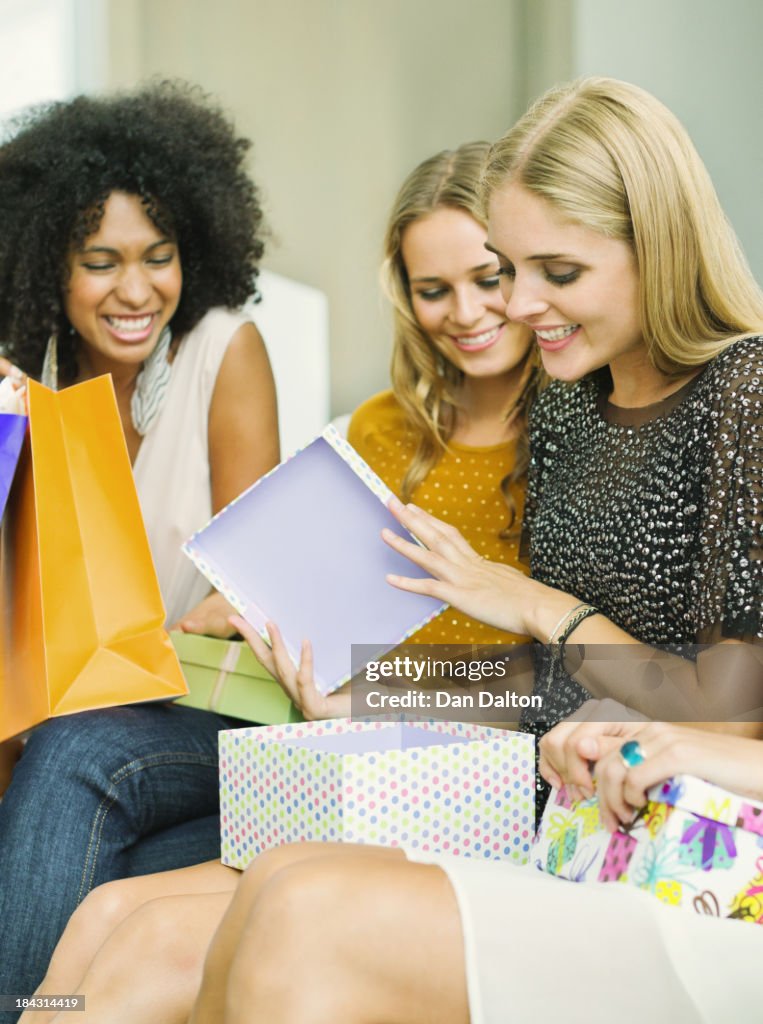 Woman opening presents at birthday party