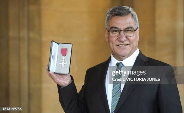 Founder and Director at Afghanistan and Central Asian Association Nooralhaq Nasimi poses with his medal after being appointed a Member of the Order...