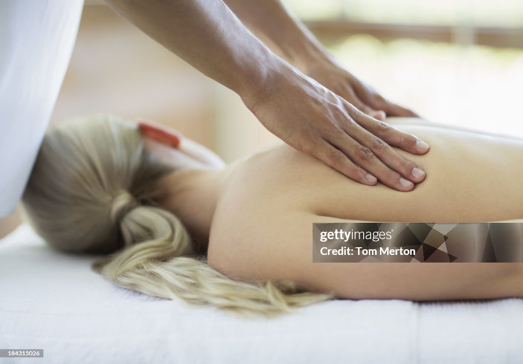 Woman receiving massage at spa