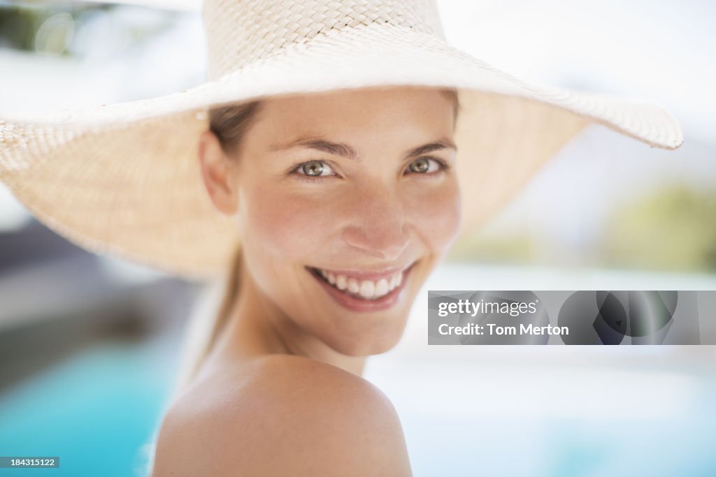Portrait of smiling woman in sun hat