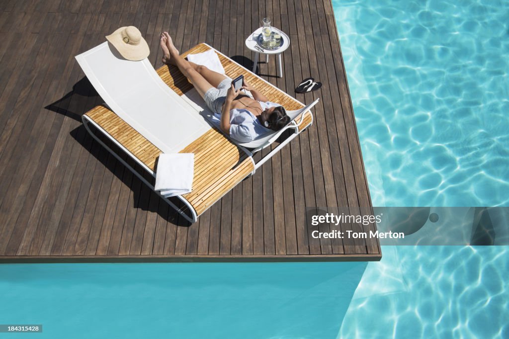 Man relaxing on lounge chair at poolside