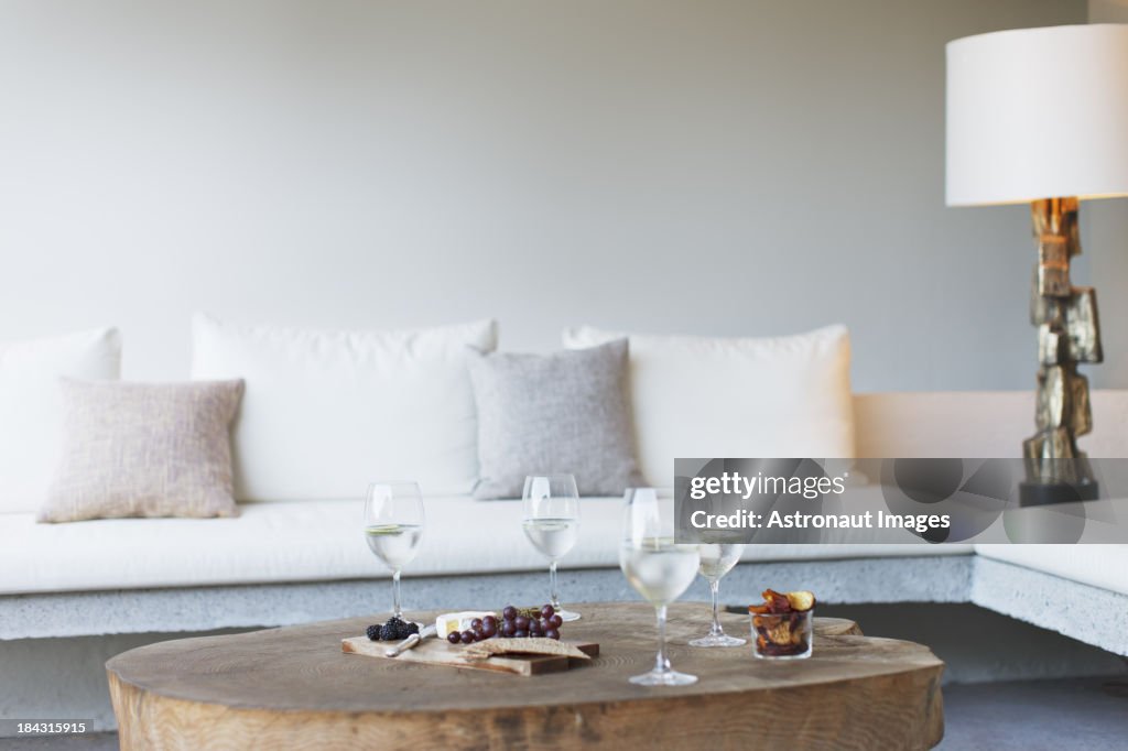 Wine and cheese on coffee table in modern living room