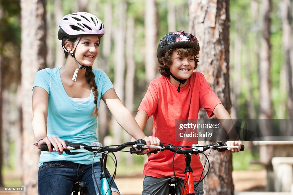 Siblings riding mountain bikes