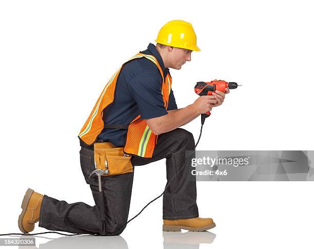 carpenter drilling with a hand drill machine - blue collar construction isolated stock pictures, royalty-free photos & images