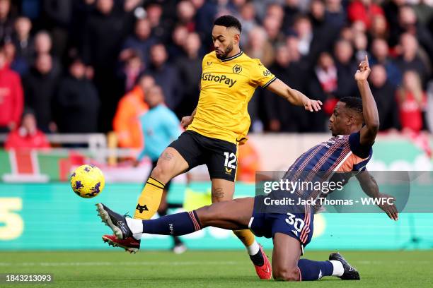 Matheus Cunha of Wolverhampton Wanderers is challenged by Willy Boly of Nottingham Forest during the Premier League match between Wolverhampton...