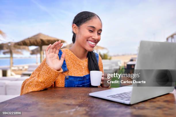 pretty digital nomad latin colombian girl does a video conference with her friends in colombia - colombia business breakfast meeting stock pictures, royalty-free photos & images