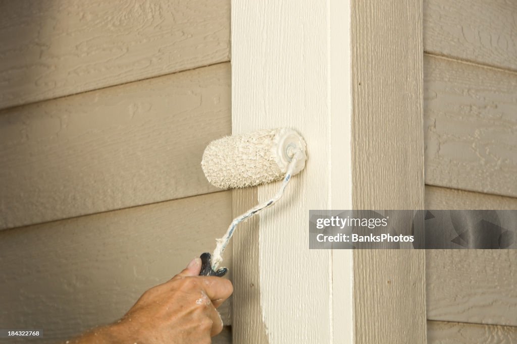 House Painter Rolling Siding Trim Board