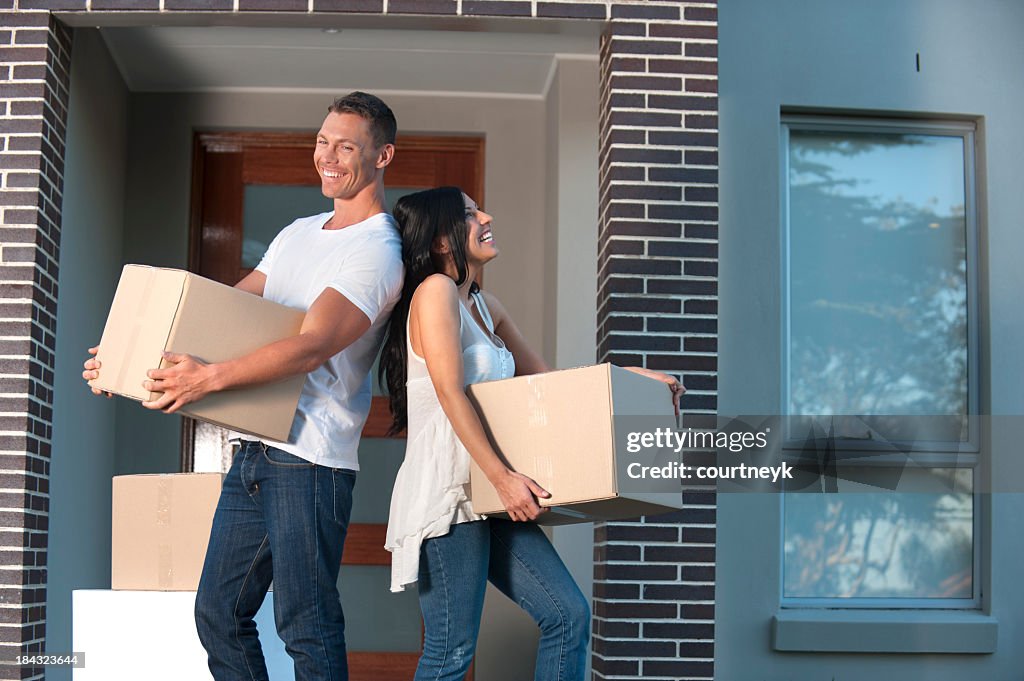 Couple carrying boxes