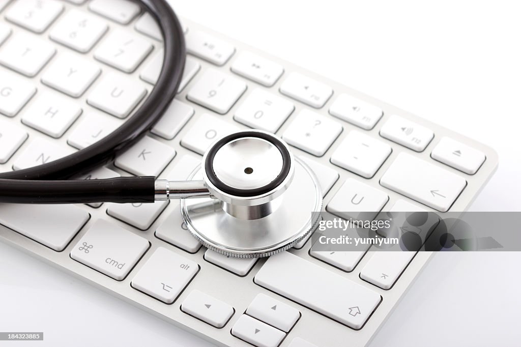 Close up of stethoscope head placed on keyboard