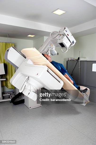 fluoroscopy machine with patient, side view - fluoroskop bildbanksfoton och bilder