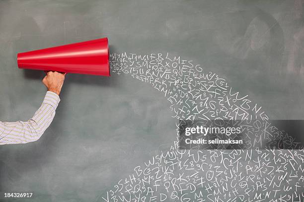 megaphone with letters and numbers on blackboard for communication pollution - human alphabet stock pictures, royalty-free photos & images