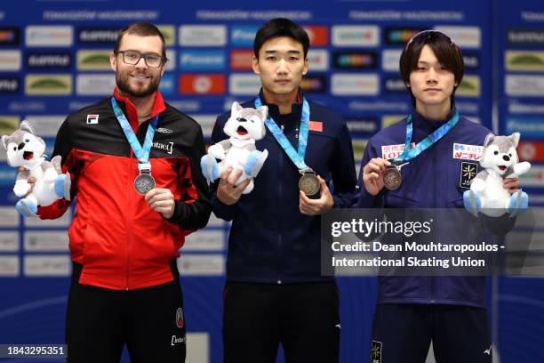 Laurent Dubreuil of Canada poses with the silver medal, Tingyu Gao of China with the gold medal and Wataru Morishige of Japan with the bronze medal...