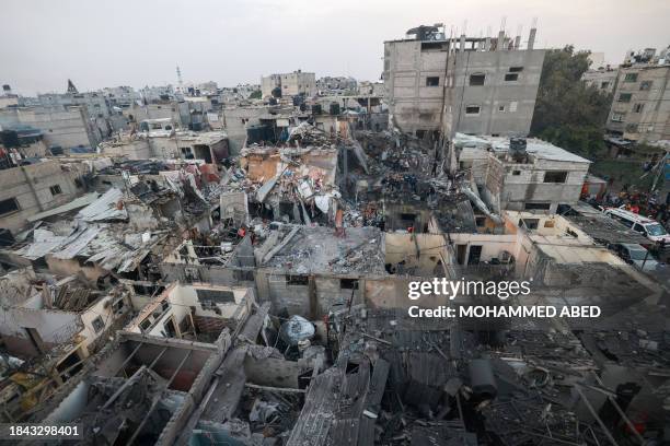 Palestinians check the destruction following Israeli bombardment in Rafah, in the southern Gaza Strip on December 12 amid ongoing battles between...