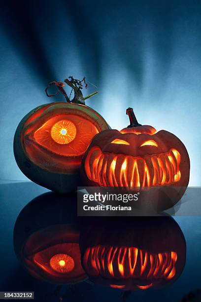 two artistically carved jack-o-lantern pumpkins - scary pumpkin faces stock pictures, royalty-free photos & images