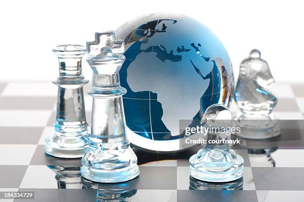 global strategy concept with chess pieces - queens globe stock pictures, royalty-free photos & images