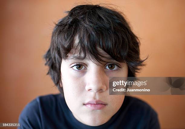 young boy looking at the camera - young face serious at camera stockfoto's en -beelden