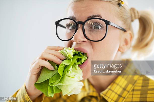 crazy nerd woman with the cabbage leaf in her mouth - thick white women stock pictures, royalty-free photos & images