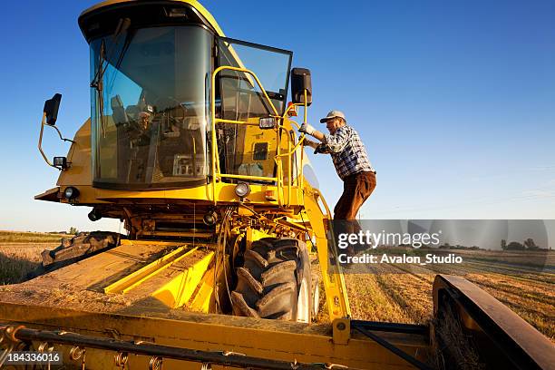 farmer enters the combine harvester - agricultural equipment stock pictures, royalty-free photos & images