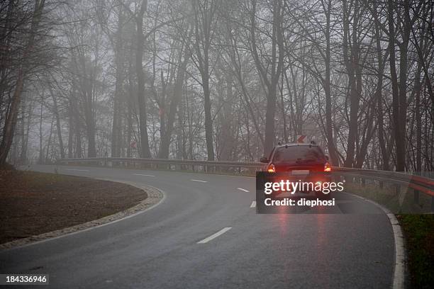 picture of a car on the road on a gray day - tail light stock pictures, royalty-free photos & images