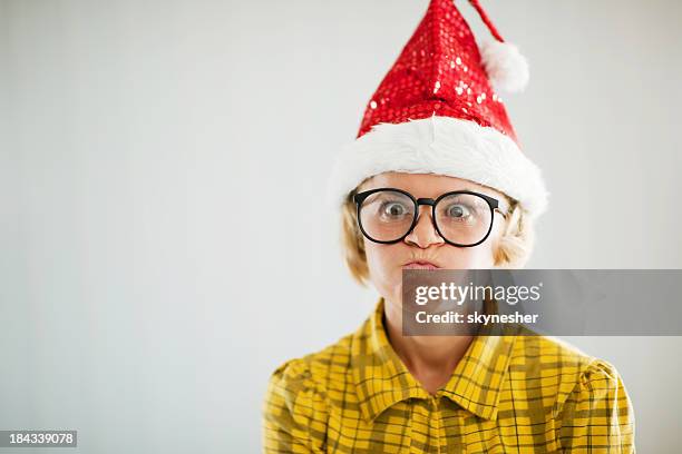 frustrated funny looking woman wearing christmas hat. - christmas angry stock pictures, royalty-free photos & images