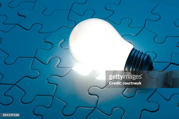 illuminated light globe on a jigsaw puzzle - connect the dots puzzle stock pictures, royalty-free photos & images