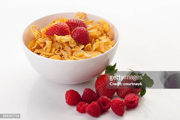 cornflakes in a bowl with strawberries - cornflakes stock pictures, royalty-free photos & images
