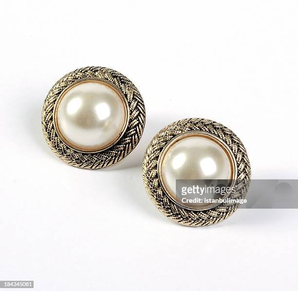 a pair of gold framed pearl stud earrings - pearl earring stockfoto's en -beelden
