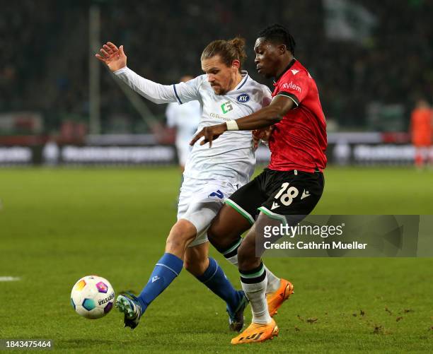 Sebastian Jung of Karlsruher SC and Derrick Koehn of Hannover 96 battle for the ball during the Second Bundesliga match between Hannover 96 and...