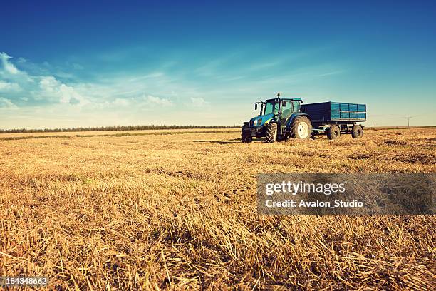 tractor in the stubble field - straw stock pictures, royalty-free photos & images